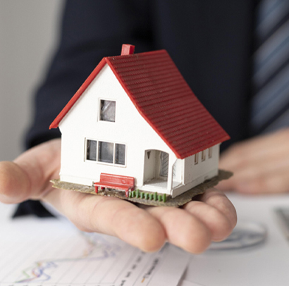 Man holding a toy house.