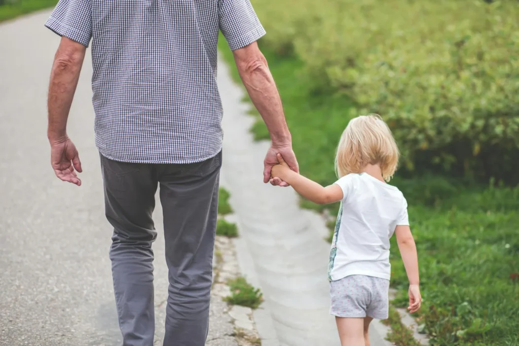A father walking with his daughter.