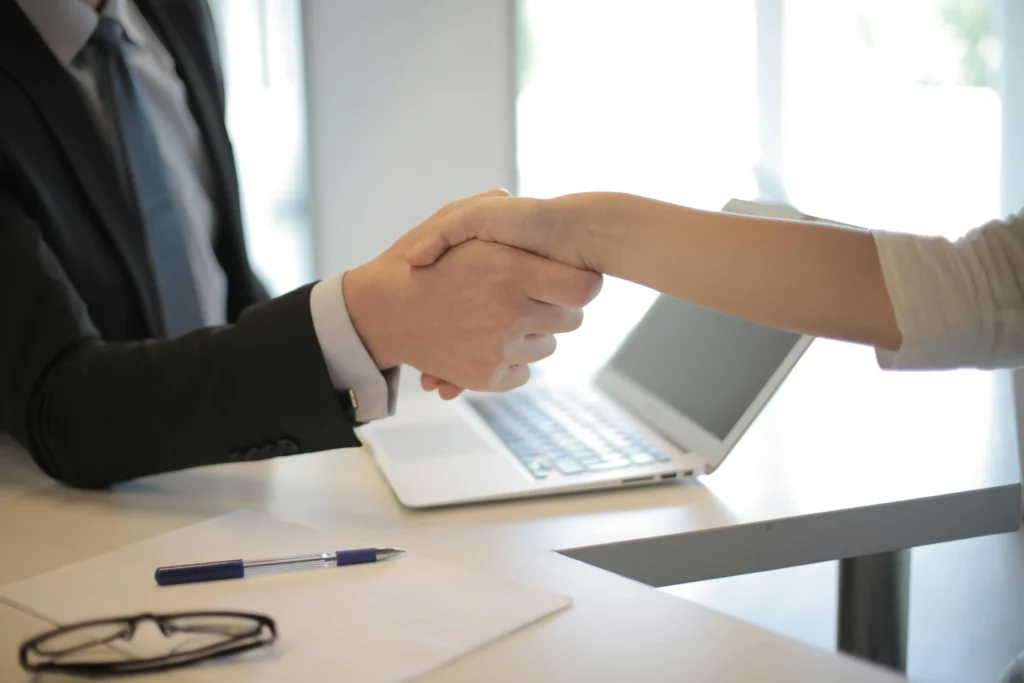 An attorney shaking a client's hand.