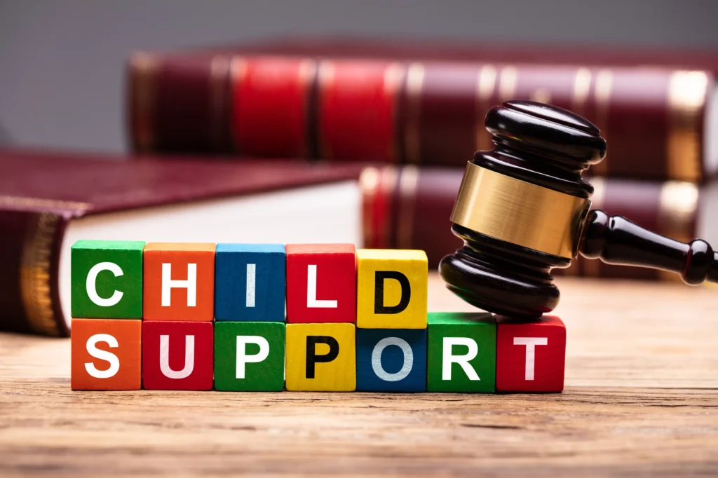 Letter blocks spelling out child support a gavel sitting on them.