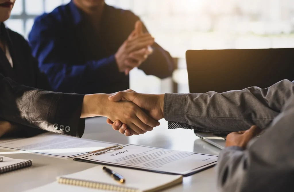 An attorney shaking hands with clients.