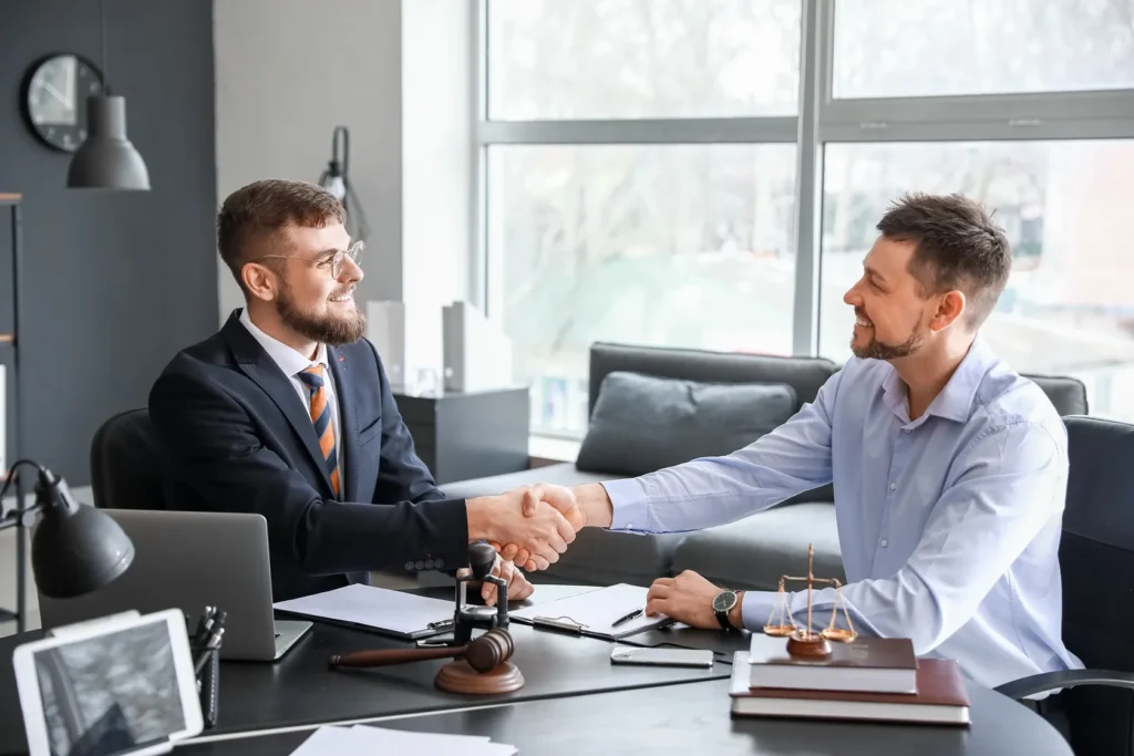 An attorney shaking hands with his client.