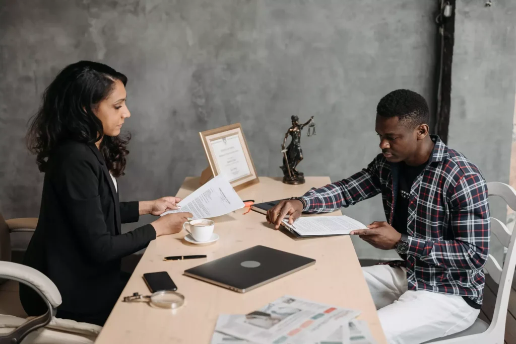 An attorney working with her client on paperwork.