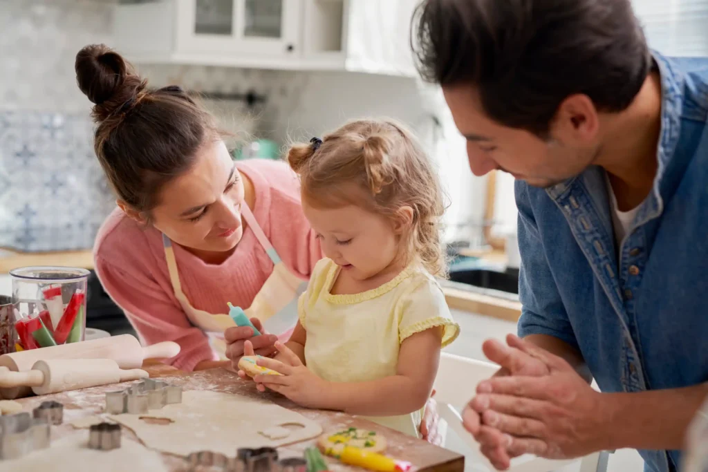 Parents baking cookies together, symbolizing family unity in a domestic setting.
